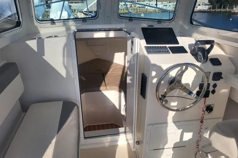 Slide: The Image of 2021 Steiger Craft 255 DV MIAMI boat interior with steering wheel and control panel. - 15