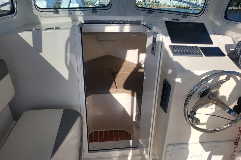 Slide: The Image of 2021 Steiger Craft 255 DV MIAMI cabin interior with helm and seating area. - 16