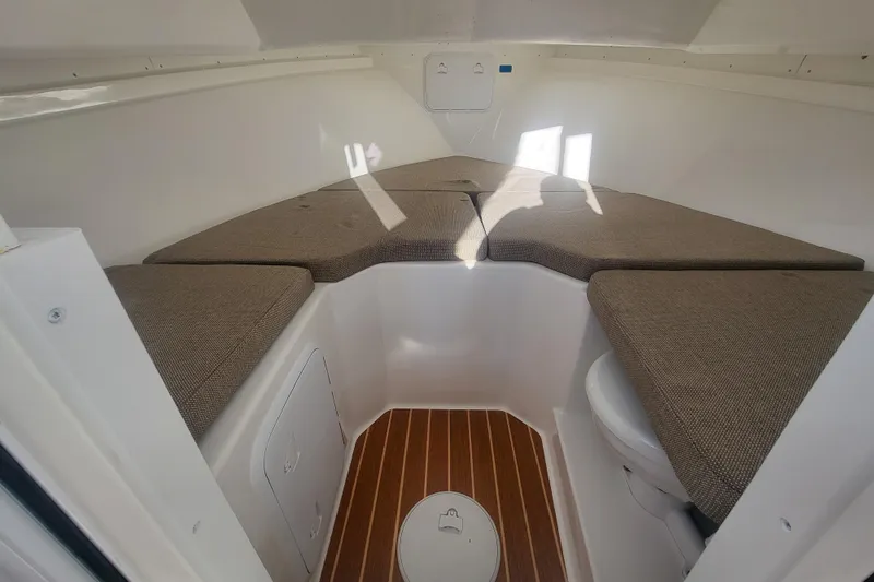 Slide: The Image of 2021 Steiger Craft 255 DV MIAMI cabin interior with cushioned seating and wood flooring. - 17