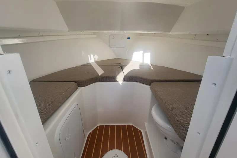 Slide: The Image of 2021 Steiger Craft 255 DV MIAMI cabin interior with cushioned seating and wooden flooring. - 18