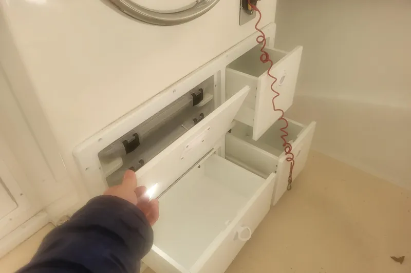 Slide: The Image of 2021 Steiger Craft 255 DV MIAMI boat on lift, blue hull, dockside view. - 2