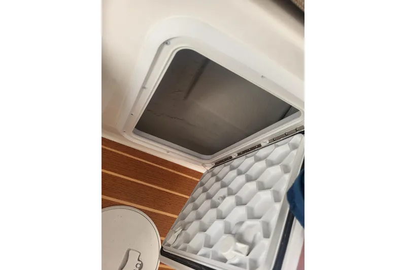Slide: The Image of Open hatch on 2021 Steiger Craft 255 DV MIAMI boat, showing interior storage space. - 26