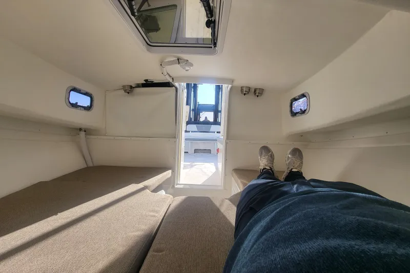 Slide: The Image of Interior cabin view of 2021 Steiger Craft 255 DV MIAMI boat, showing seating and windows. - 27