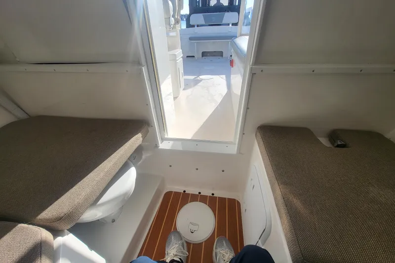 Slide: The Image of 2021 Steiger Craft 255 DV MIAMI cabin interior with cushioned seating and wooden flooring. - 30