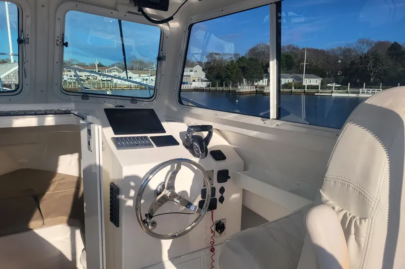 Slide: The Image of 2021 Steiger Craft 255 DV MIAMI boat interior with steering wheel and navigation equipment. - 31