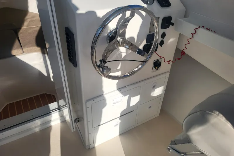 Slide: The Image of Steiger Craft 255 DV MIAMI 2021 boat helm with steering wheel and control panel. - 32