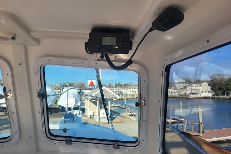 Slide: The Image of Interior view of 2021 Steiger Craft 255 DV MIAMI boat with marina background. - 35