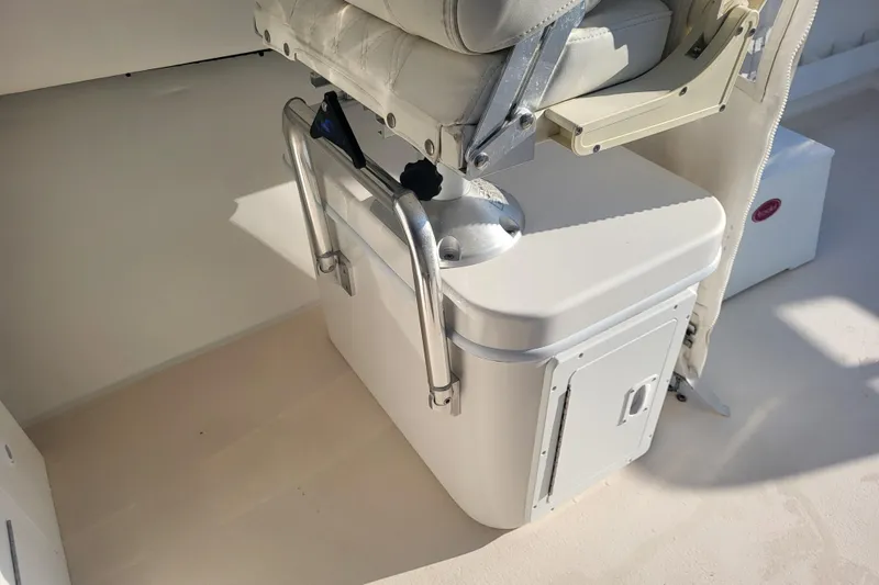 Slide: The Image of 2021 Steiger Craft 255 DV MIAMI boat interior with cushioned seat and storage compartment. - 44