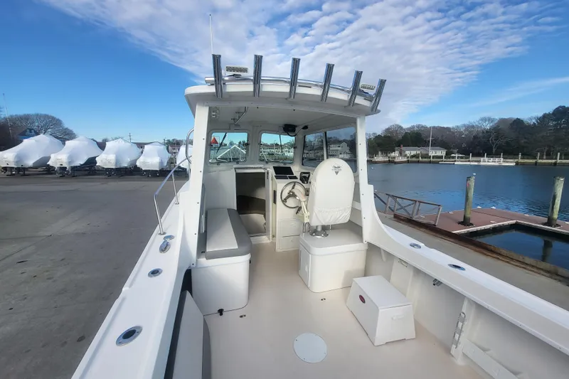 Slide: The Image of 2021 Steiger Craft 255 DV MIAMI boat docked, showcasing spacious deck and helm area. - 47