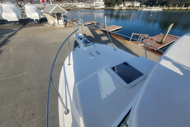 Slide: The Image of 2021 Steiger Craft 255 DV MIAMI boat docked near a serene waterfront. - 60