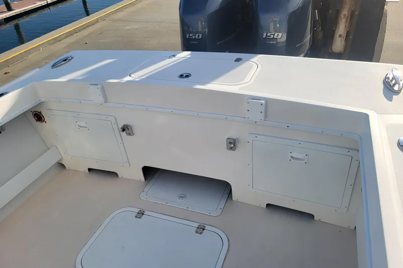 Slide: The Image of 2021 Steiger Craft 255 DV MIAMI boat deck with storage compartments and twin Yamaha 150 engines. - 69