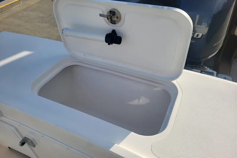 Slide: The Image of Open storage compartment on 2021 Steiger Craft 255 DV MIAMI boat, showcasing interior space. - 70