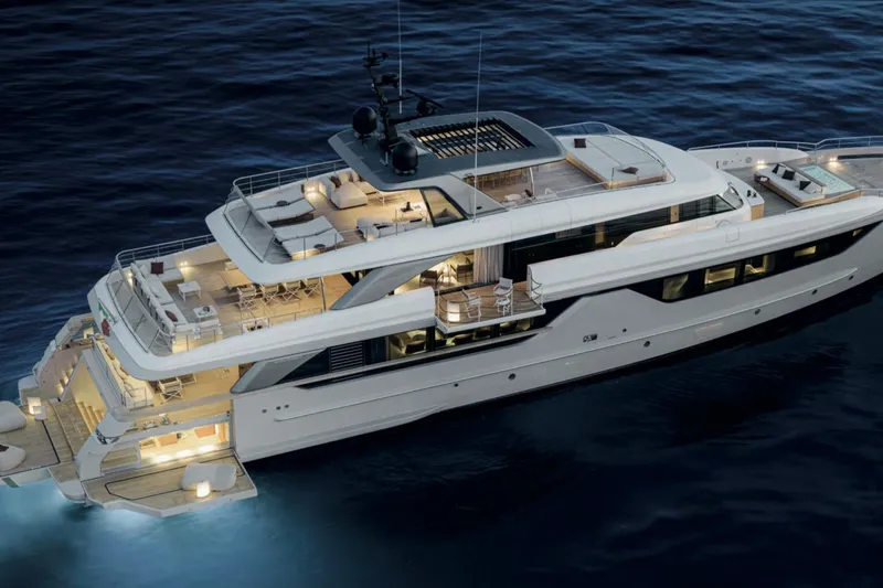 Slide: The Image of Luxurious 2028 Sanlorenzo SD132 yacht illuminated on calm ocean waters at night. - 10