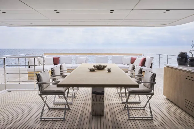 Slide: The Image of Luxurious Sanlorenzo SD132 yacht deck with elegant dining area, ocean view, 2028 model. - 20