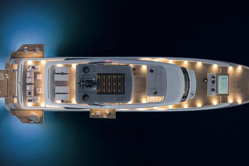 Slide: The Image of Aerial view of 2028 Sanlorenzo SD132 yacht with illuminated decks at night. - 9