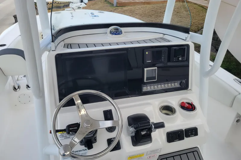 Slide: The Image of 2020 Tidewater 2700 Carolina Bay boat console with steering wheel and navigation controls. - 10