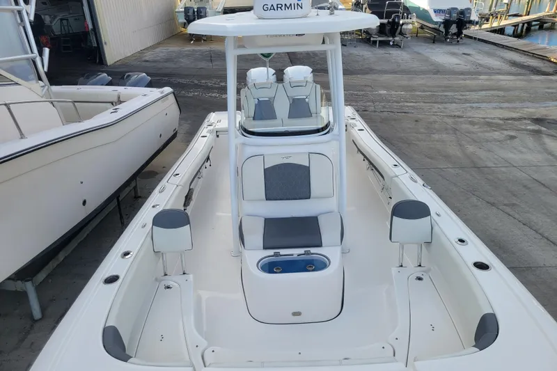 Slide: The Image of 2020 Tidewater 2700 Carolina Bay boat docked, featuring spacious seating and Garmin equipment. - 14