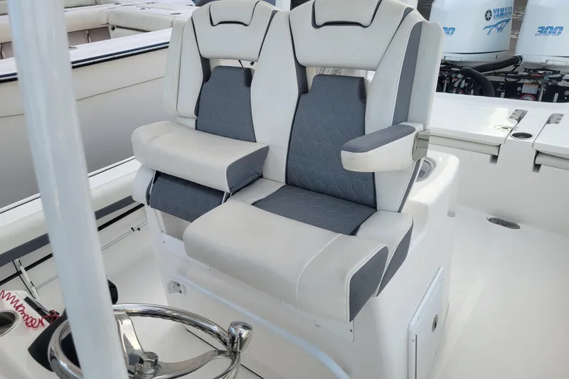 Slide: The Image of 2020 Tidewater 2700 Carolina Bay boat with dual cushioned seats and steering wheel. - 15