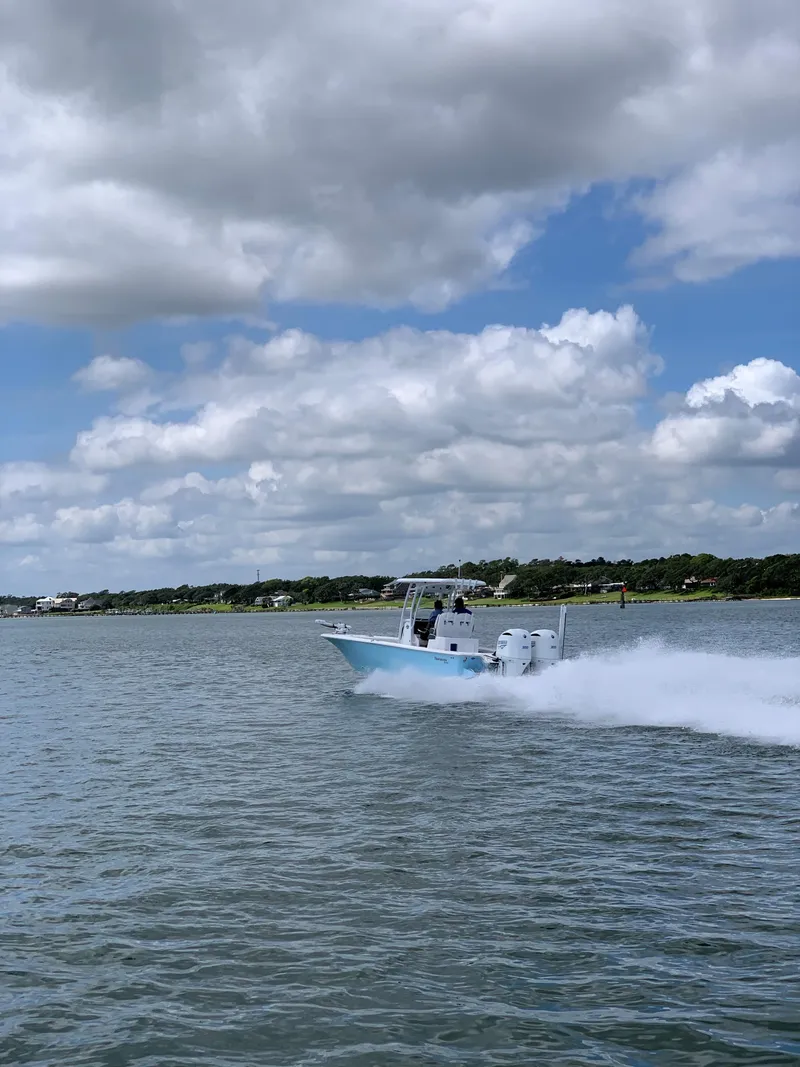 Slide: The Image of Tidewater 2700 Carolina Bay 2020 cruising on water under cloudy sky. - 3