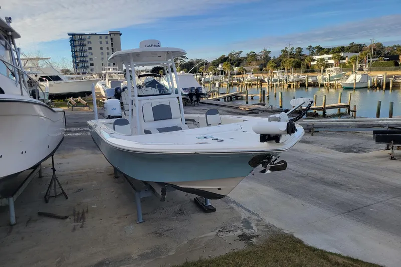 Slide: The Image of 2020 Tidewater 2700 Carolina Bay boat docked at a marina with clear skies. - 5