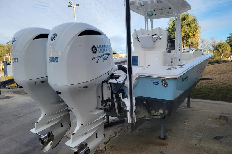 Slide: The Image of 2020 Tidewater 2700 Carolina Bay boat with dual Yamaha 300 engines, docked outdoors. - 6