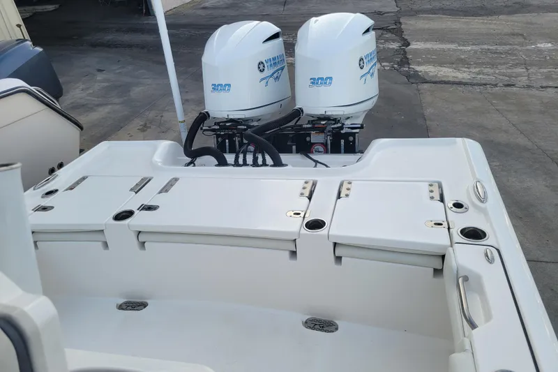 Slide: The Image of 2020 Tidewater 2700 Carolina Bay boat with dual Yamaha 300 engines, docked on concrete. - 8