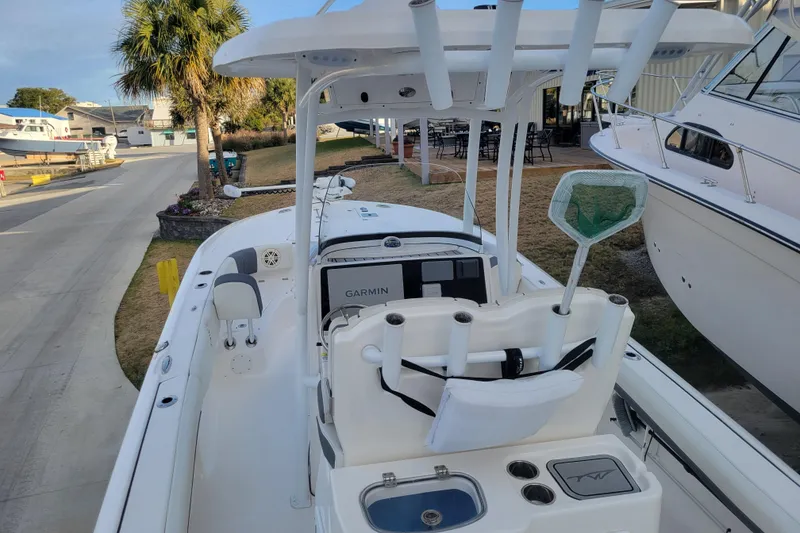 Slide: The Image of 2020 Tidewater 2700 Carolina Bay boat with Garmin equipment, docked near palm trees. - 9