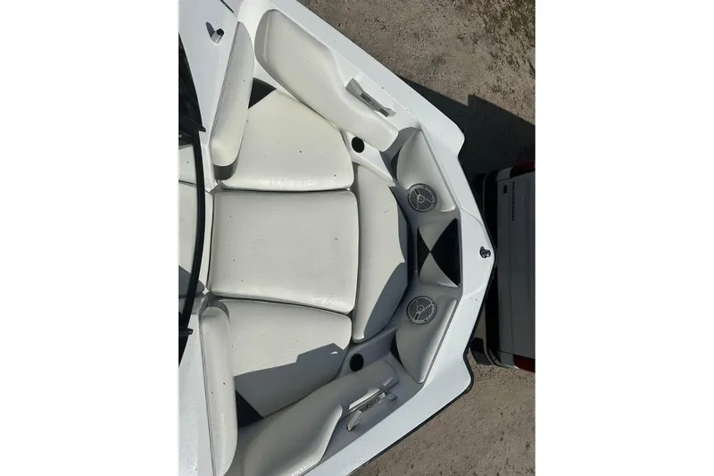 Slide: The Image of 2012 Axis A20 boat interior with white seating and speakers. - 8
