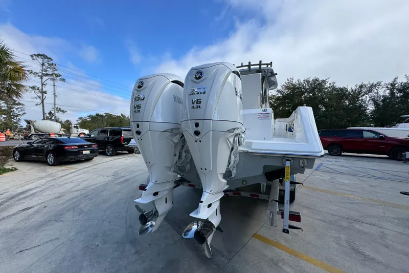 Slide: The Image of 2026 Solace 30 CS boat with twin Yamaha V6 4.2L engines in a parking lot. - 13