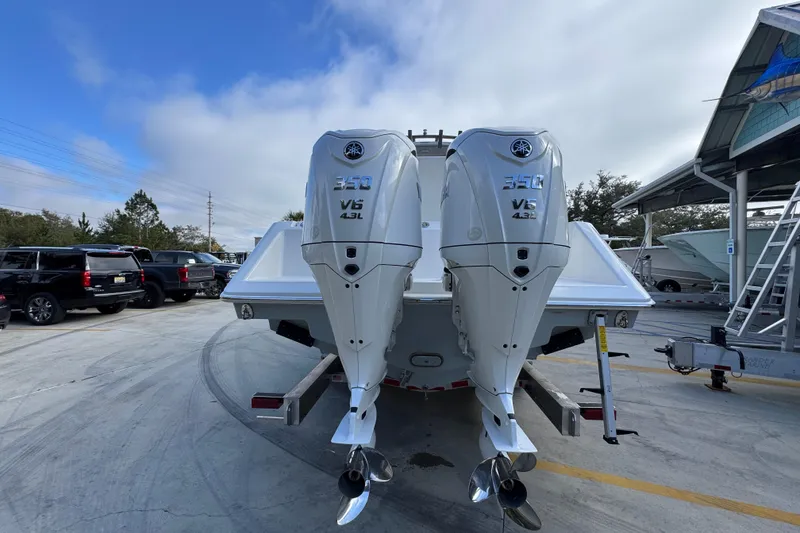 Slide: The Image of 2026 Solace 30 CS boat with dual Yamaha 350 V6 outboard engines in a marina. - 14