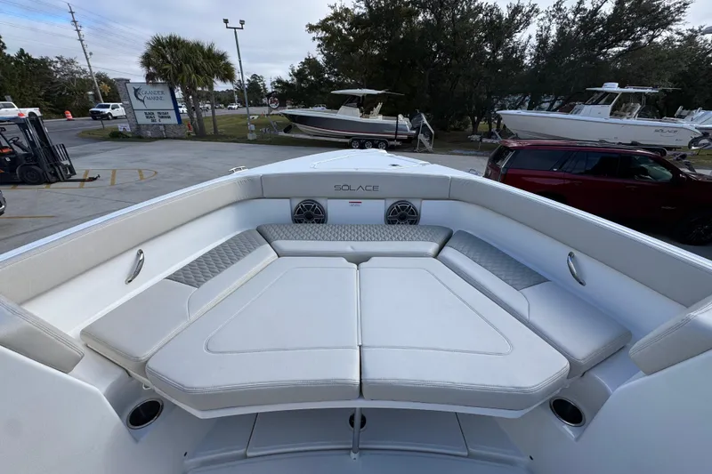 Slide: The Image of 2026 Solace 30 CS boat interior with cushioned seating and sleek design. - 19