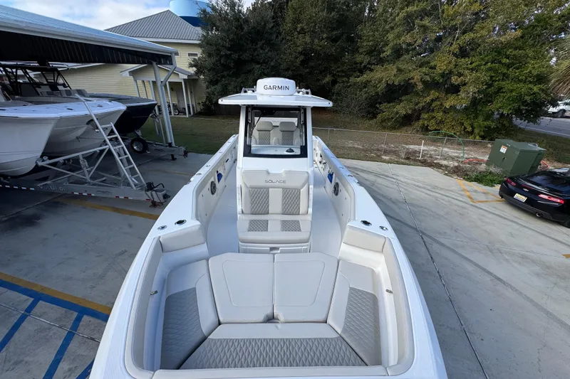 Slide: The Image of 2026 Solace 30 CS boat with spacious seating, docked outdoors. - 21