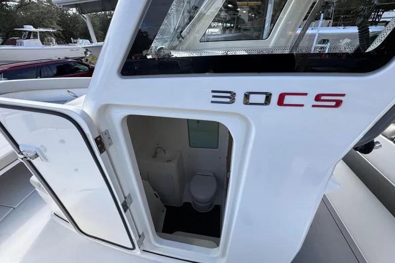 Slide: The Image of 2026 Solace 30 CS boat with open cabin door revealing interior amenities. - 27