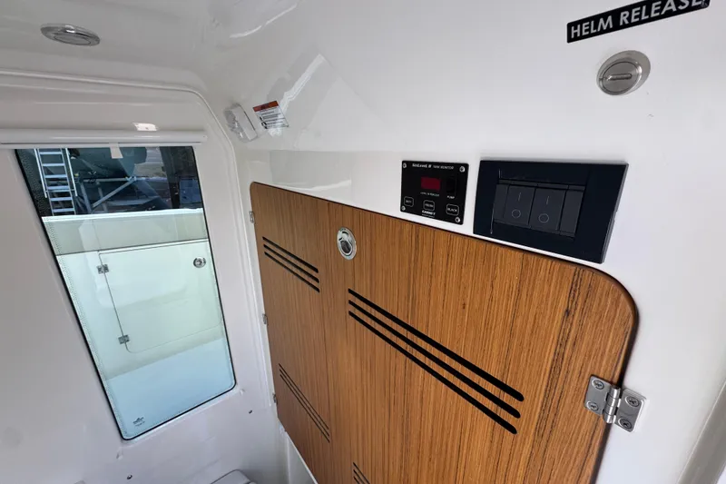 Slide: The Image of Interior of 2026 Solace 30 CS boat with wooden panel and control switches. - 29