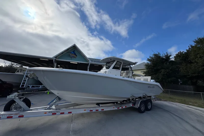 Slide: The Image of 2026 Solace 30 CS boat on trailer under cloudy sky. - 3