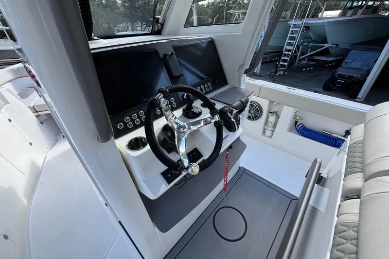 Slide: The Image of 2026 Solace 30 CS boat helm with modern controls and steering wheel. - 34