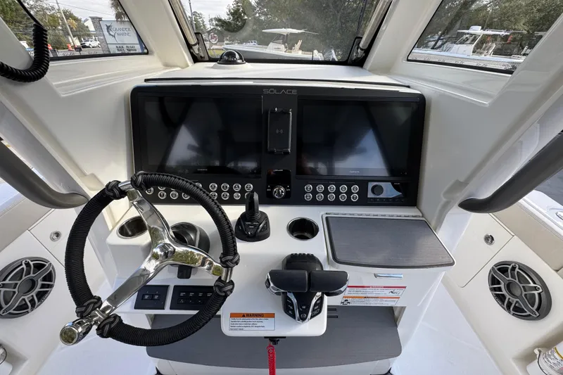 Slide: The Image of Helm of 2026 Solace 30 CS boat with modern controls and navigation screens. - 35
