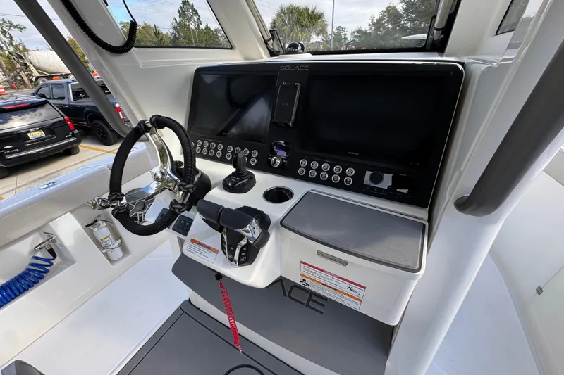 Slide: The Image of 2026 Solace 30 CS boat dashboard with steering wheel and control panel. - 37