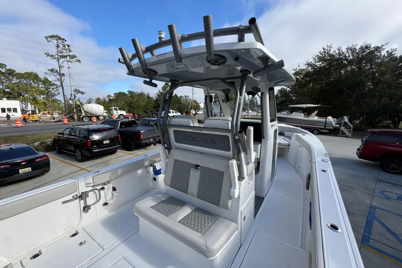 Slide: The Image of 2026 Solace 30 CS boat with sleek design, parked outdoors, showcasing modern seating and equipment. - 41
