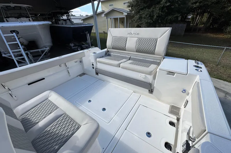 Slide: The Image of Interior of 2026 Solace 30 CS boat with cushioned seating and storage compartments. - 44
