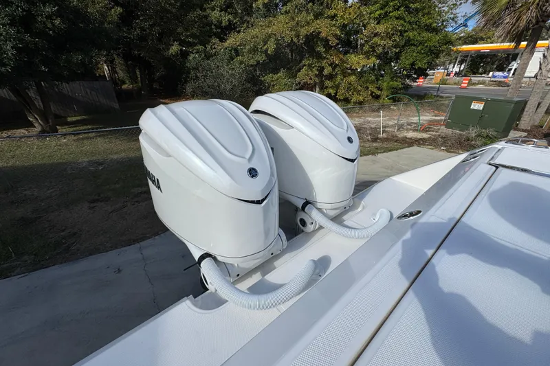 Slide: The Image of Twin Yamaha outboard engines on a 2026 Solace 30 CS boat, parked outdoors. - 49