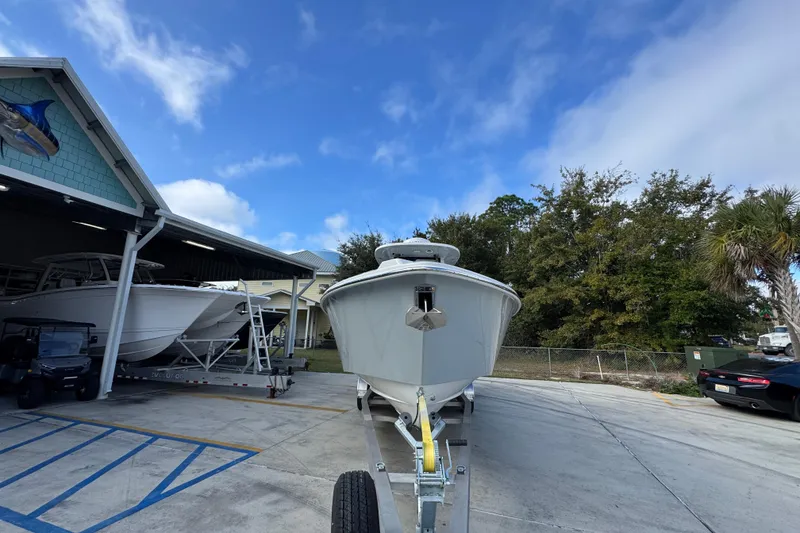 Slide: The Image of 2026 Solace 30 CS boat on trailer, parked outdoors under blue sky. - 6