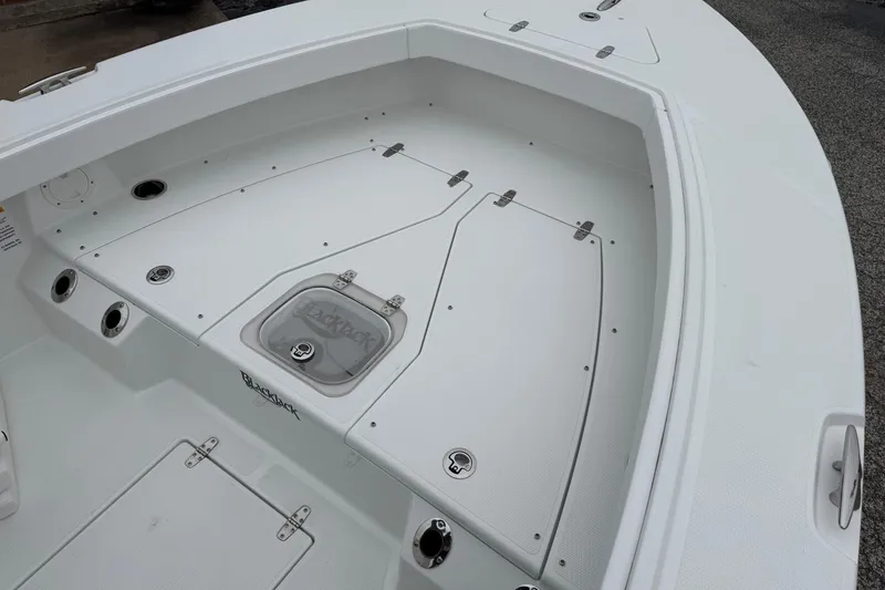 Slide: The Image of 2026 BlackJack 256 Coastal boat deck with storage compartments and sleek design. - 10