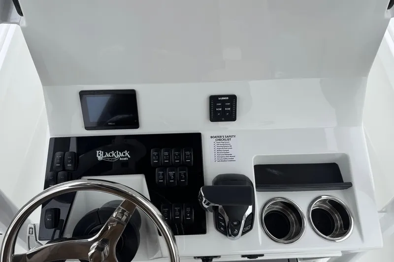 Slide: The Image of 2026 BlackJack 256 Coastal boat dashboard with steering wheel and control panel. - 15