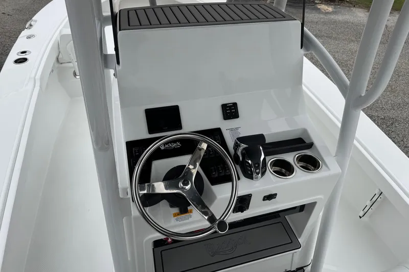 Slide: The Image of 2026 BlackJack 256 Coastal boat console with steering wheel and controls. - 16