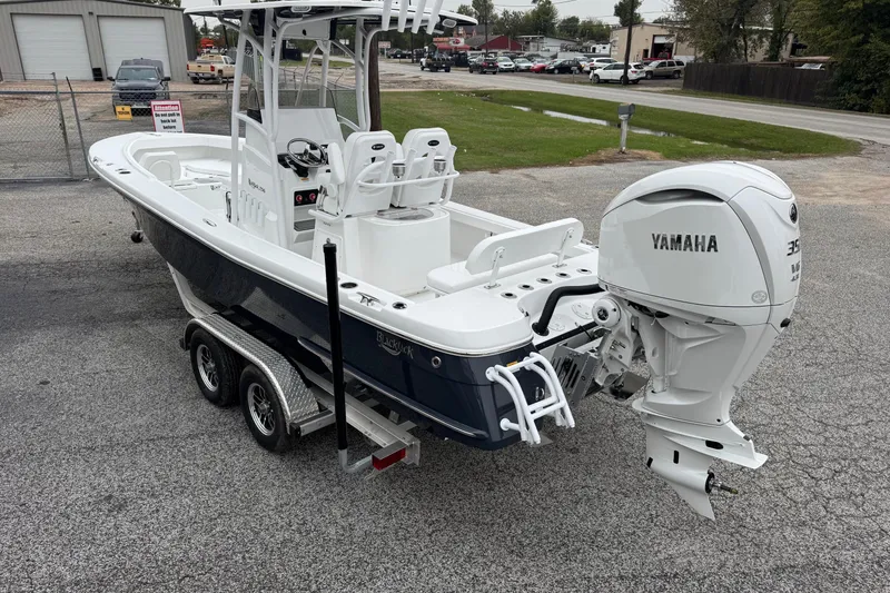 Slide: The Image of 2026 BlackJack 256 Coastal boat with Yamaha engine on a trailer in a parking lot. - 2