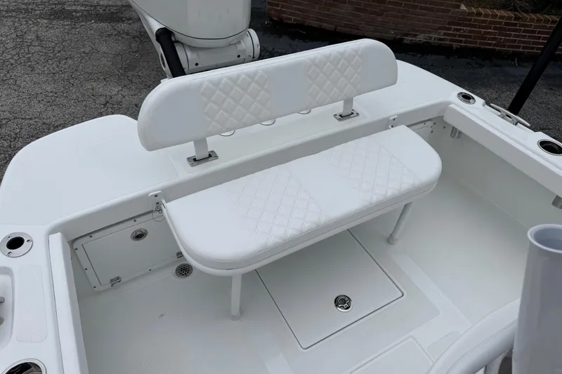 Slide: The Image of 2026 BlackJack 256 Coastal boat interior with white cushioned seating and storage compartments. - 20