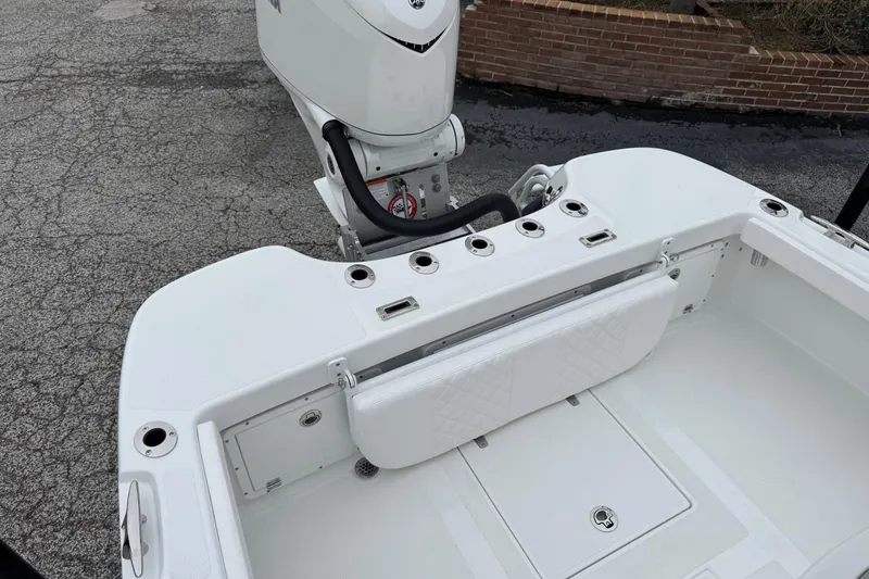 Slide: The Image of 2026 BlackJack 256 Coastal boat with outboard motor and seating area. - 21