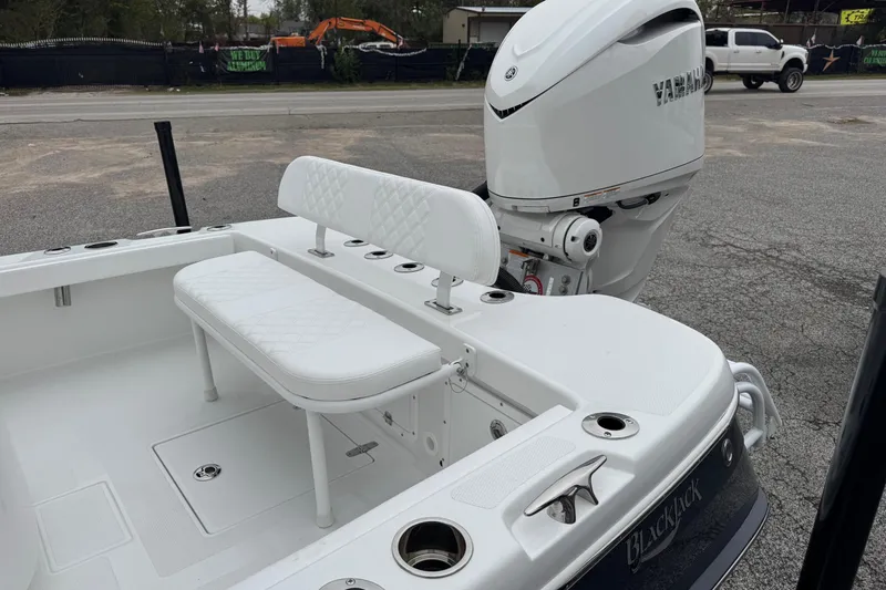 Slide: The Image of 2026 BlackJack 256 Coastal boat with Yamaha engine, featuring white seating and sleek design. - 22