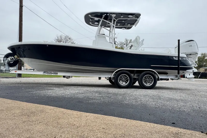 Slide: The Image of 2026 BlackJack 256 Coastal boat on trailer, side view, overcast sky. - 5